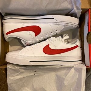 White Nike sneakers with red logo.